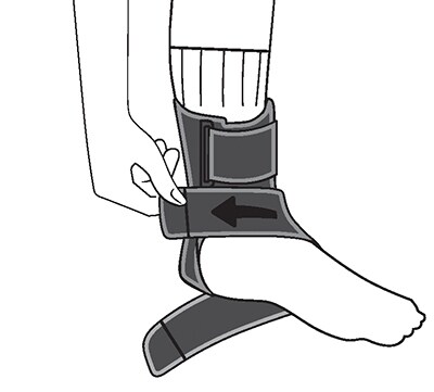 Pulling up and attaching the left foot support strap.