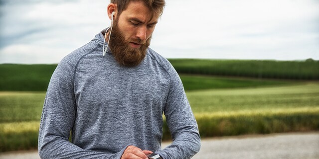 Man checking heart rate on watch before workout