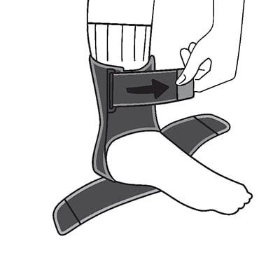 Sliding foot into Sport Deluxe Ankle Stabilizer. Looping the top ankle wrap strap through the buckle, then securing.