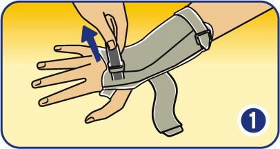 Loosening the fasteners and inserting hand into wrist support brace.