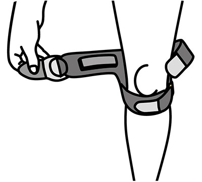 Positioning knee stabilizer behind knee with straps above and below kneecap.