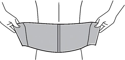 Placing abdominal support on bed, lying down on it, and stretching over abdomen.